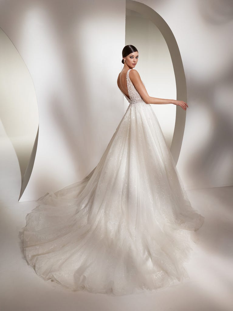 Tulle wedding dress with sleeveless bodice and sweetheart neckline. The embroidered lace creates a fabulous 3D effect, and the removable sleeves will look perfect during the ceremony.