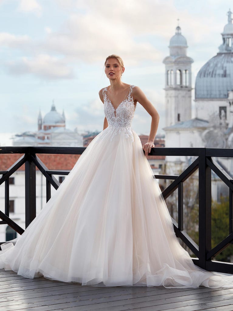 Tulle wedding dress with sleeveless bodice and sweetheart neckline. The embroidered lace creates a fabulous 3D effect, and the removable sleeves will look perfect during the ceremony.