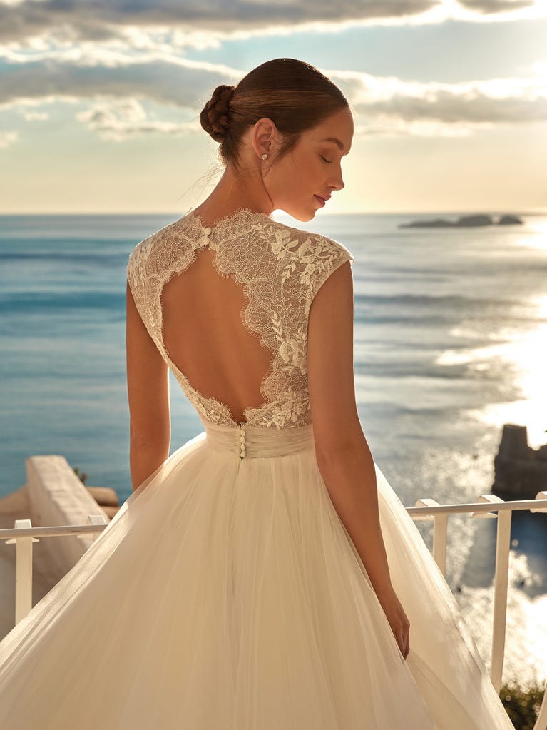 Tulle wedding dress with sleeveless bodice and sweetheart neckline. The embroidered lace creates a fabulous 3D effect, and the removable sleeves will look perfect during the ceremony.
