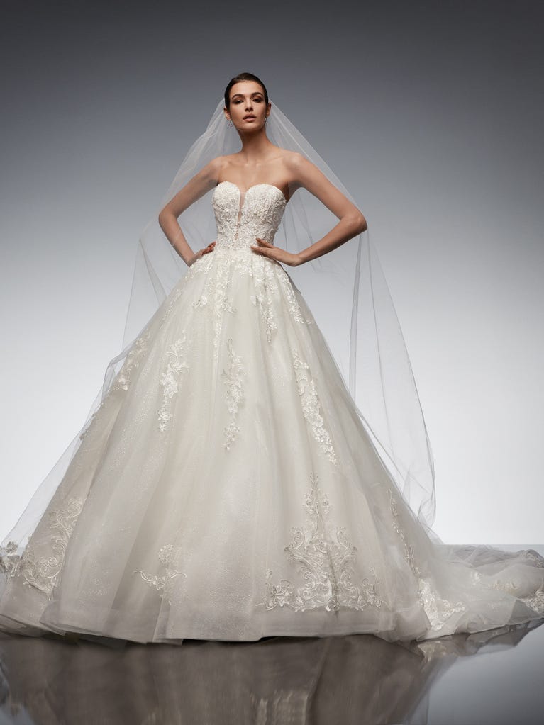 Tulle wedding dress with sleeveless bodice and sweetheart neckline. The embroidered lace creates a fabulous 3D effect, and the removable sleeves will look perfect during the ceremony.