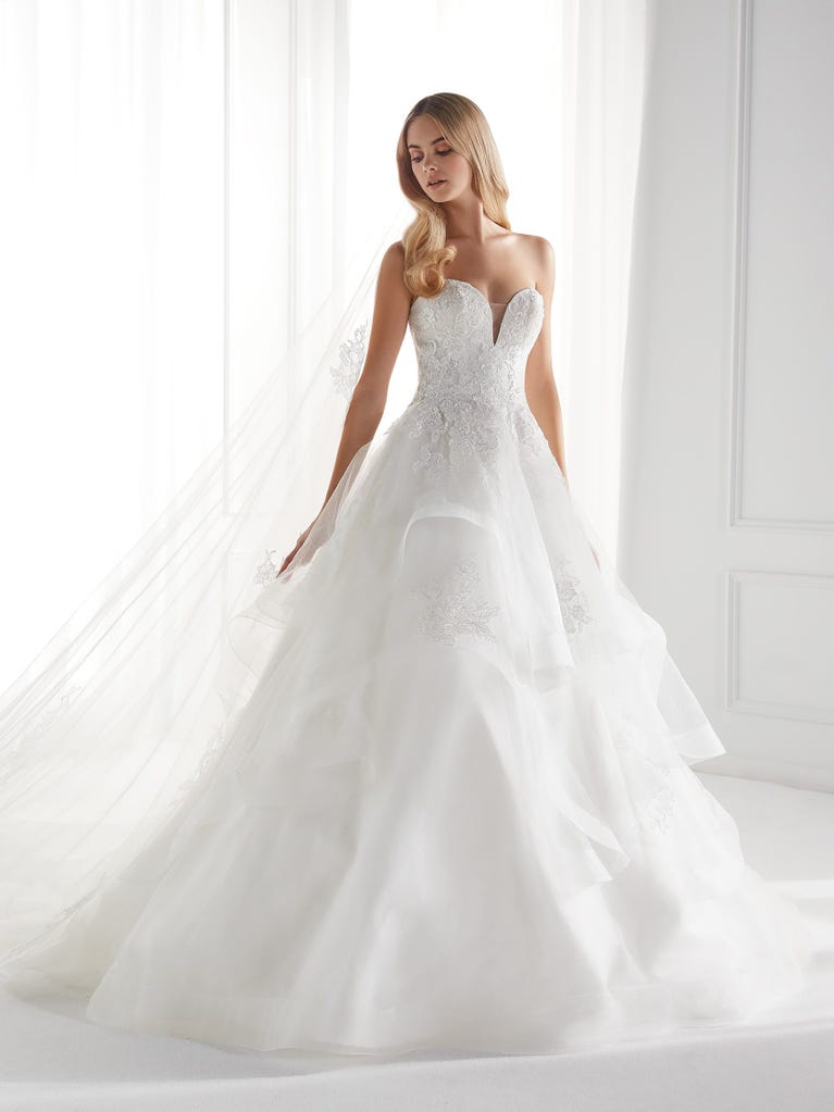 Sleeveless A-line organza wedding dress with plunging V-neck. The lace on the bodice is romantic yet modern.