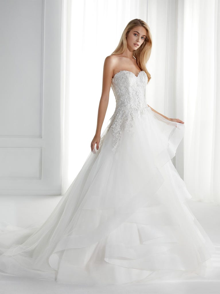 Sleeveless A-line organza wedding dress with plunging V-neck. The lace on the bodice is romantic yet modern.