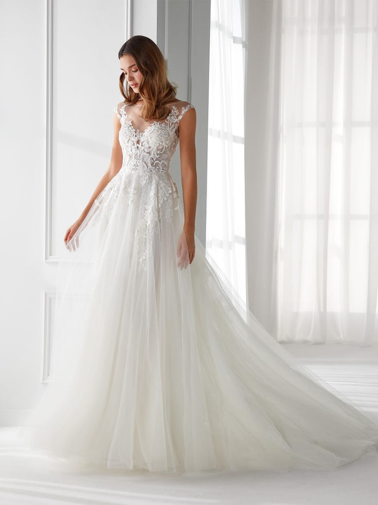 Sleeveless A-line organza wedding dress with plunging V-neck. The lace on the bodice is romantic yet modern.