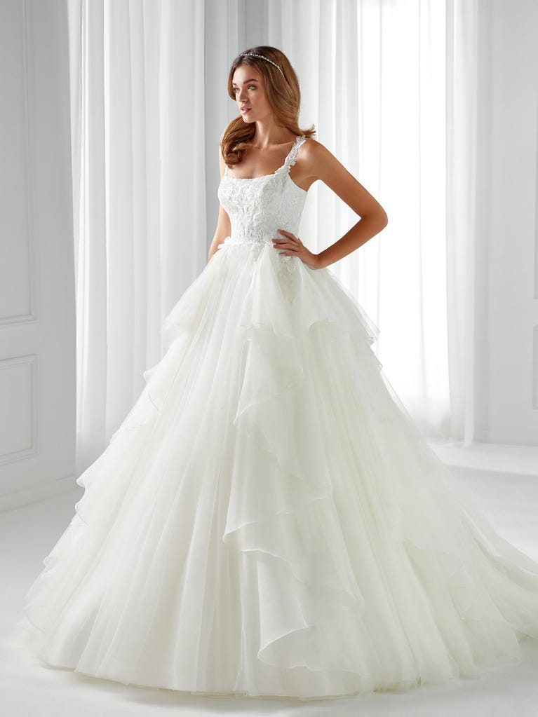 Sleeveless A-line organza wedding dress with plunging V-neck. The lace on the bodice is romantic yet modern.