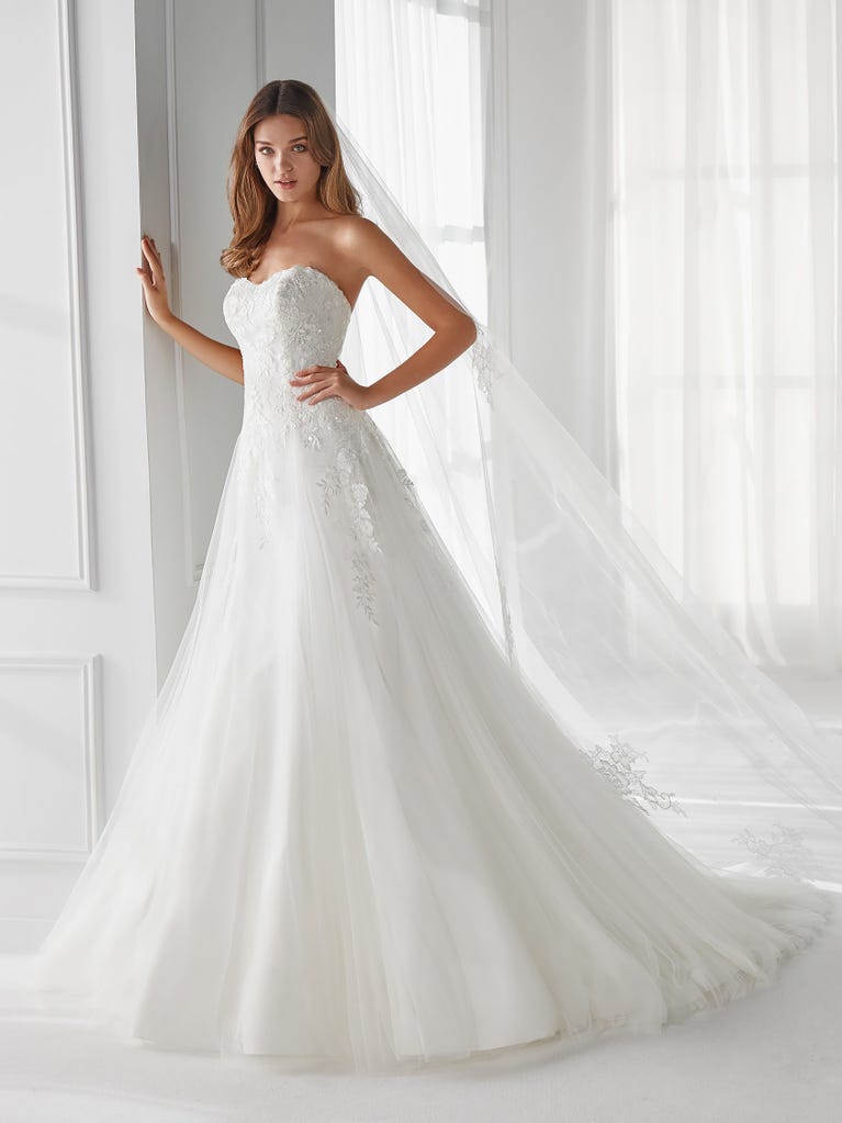 Sleeveless A-line organza wedding dress with plunging V-neck. The lace on the bodice is romantic yet modern.