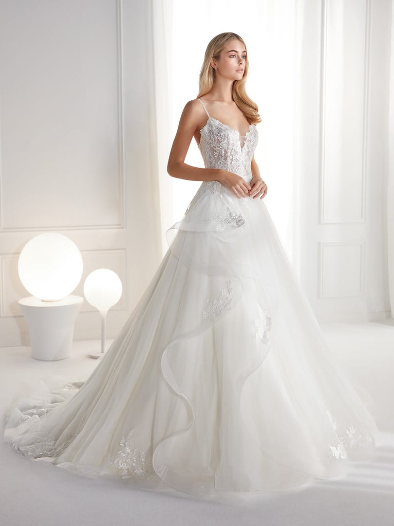 Sleeveless A-line organza wedding dress with plunging V-neck. The lace on the bodice is romantic yet modern.
