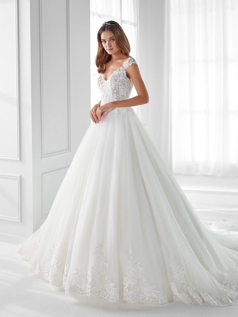 Sleeveless A-line organza wedding dress with plunging V-neck. The lace on the bodice is romantic yet modern.