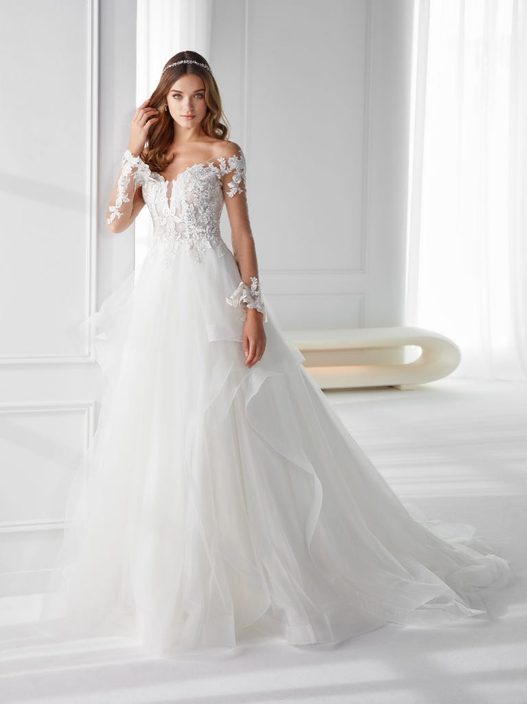 Sleeveless A-line organza wedding dress with plunging V-neck. The lace on the bodice is romantic yet modern.