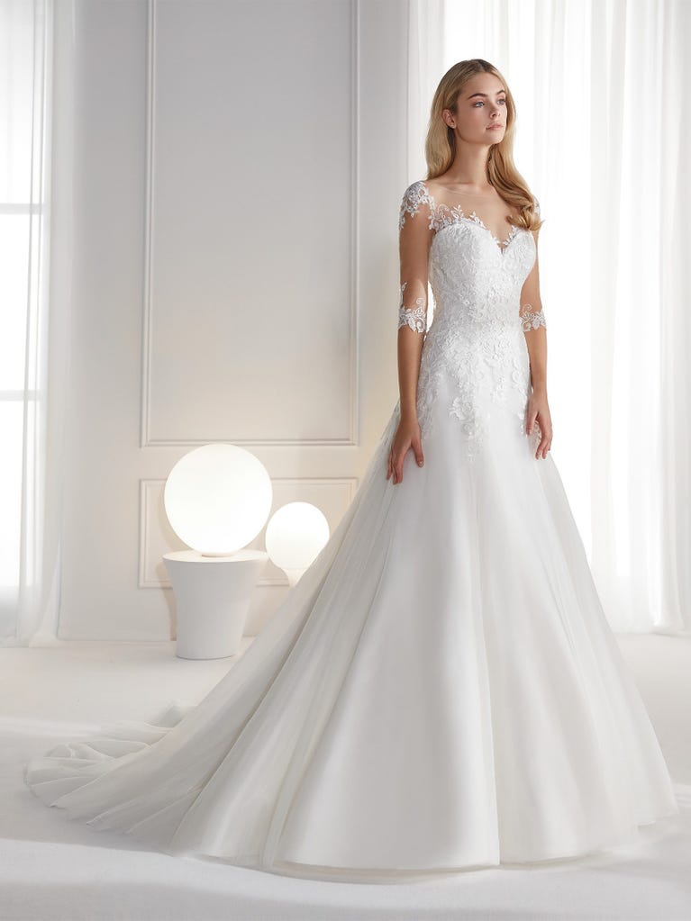 Sleeveless A-line organza wedding dress with plunging V-neck. The lace on the bodice is romantic yet modern.