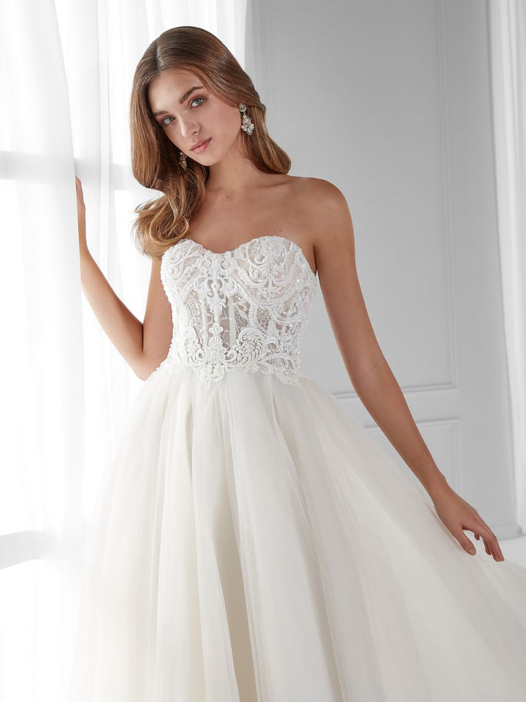 Sleeveless A-line organza wedding dress with plunging V-neck. The lace on the bodice is romantic yet modern.