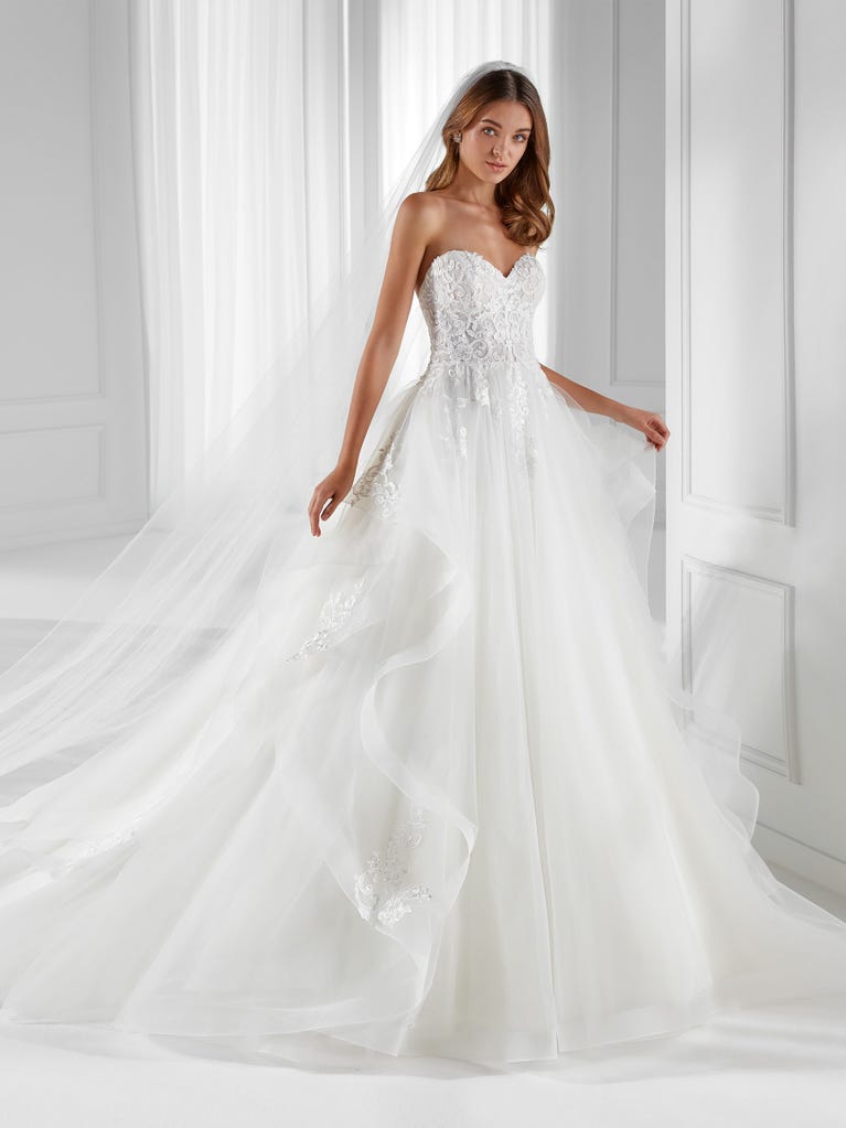 Sleeveless A-line organza wedding dress with plunging V-neck. The lace on the bodice is romantic yet modern.