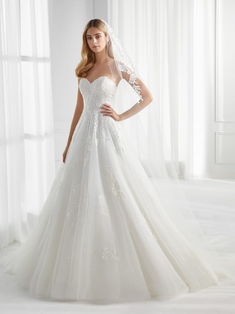 Sleeveless A-line organza wedding dress with plunging V-neck. The lace on the bodice is romantic yet modern.