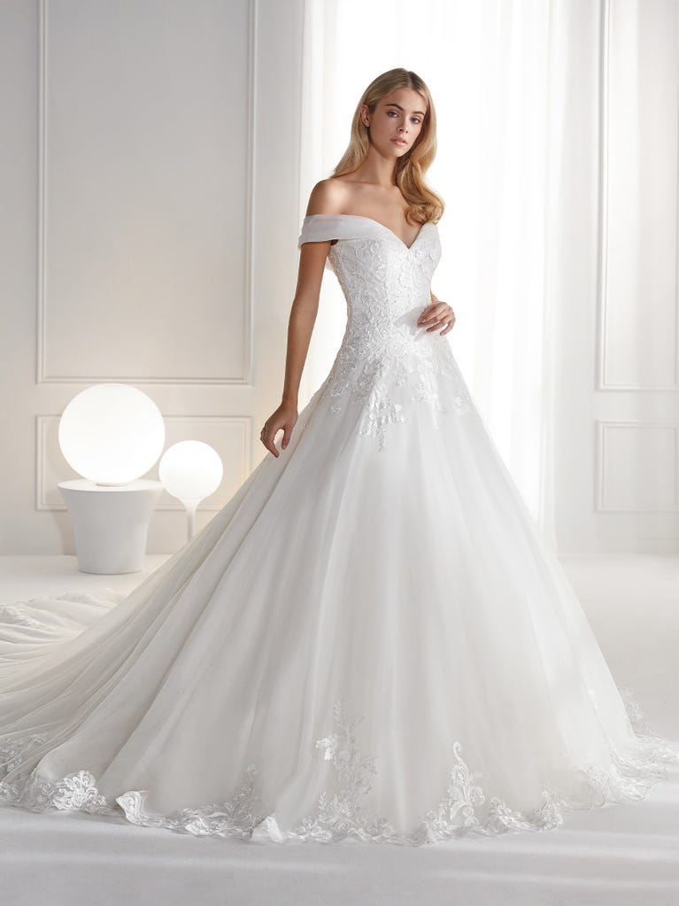 Sleeveless A-line organza wedding dress with plunging V-neck. The lace on the bodice is romantic yet modern.