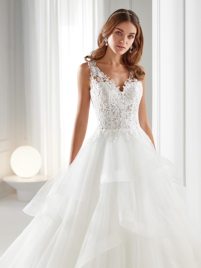Sleeveless A-line organza wedding dress with plunging V-neck. The lace on the bodice is romantic yet modern.