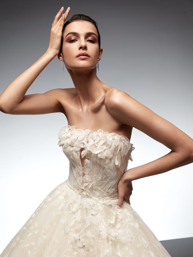 Tulle wedding dress with sleeveless bodice and sweetheart neckline. The embroidered lace creates a fabulous 3D effect, and the removable sleeves will look perfect during the ceremony.