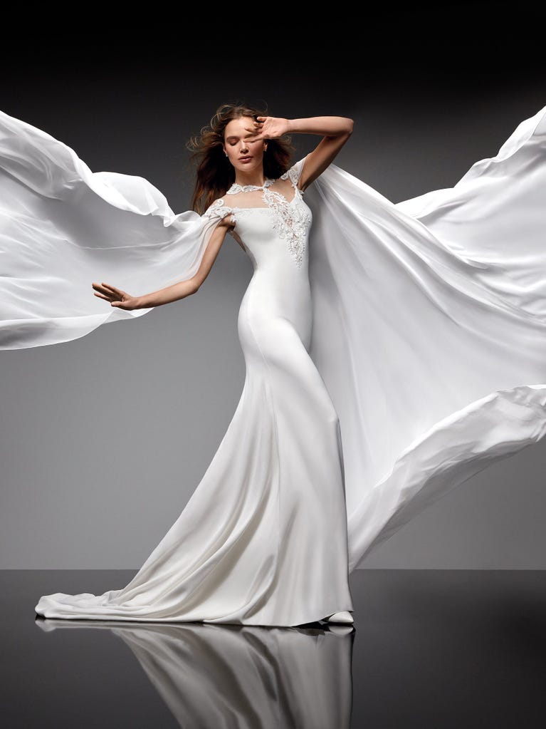 Beautiful A-line wedding dress in champagne tulle with embroidered beading and elegant 3D flowers. The straps expose the back with an elegant neckline.