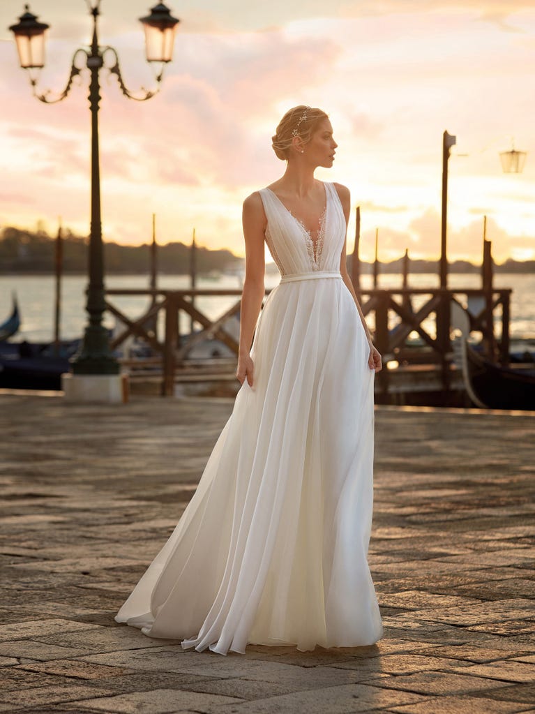 Flared wedding dress with voluminous yet lightweight tulle skirt with lace embroidered with floral motifs. For brides who dream of a romantic, feminine dress to say “I do.”