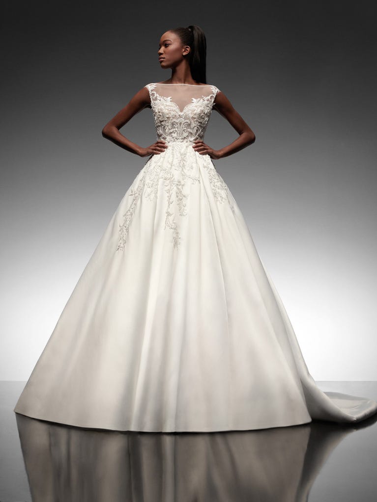 Precioso vestido de novia corte en A de tul champán con bordados de cuentas y elegantes flores 3D. Los tirantes dejan descubierta la espalda con un elegante escote.