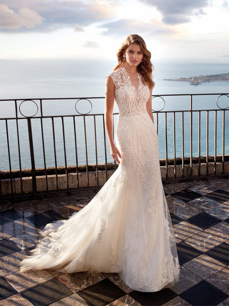 Princess wedding dress in carmine red tulle. The tulle ruffles create a light volume on the skirt and the sleeveless bodice, while the high waistline enhances the waist.