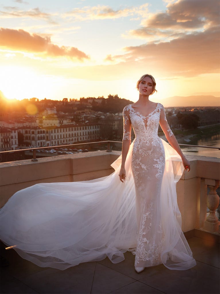 Princess wedding dress in carmine red tulle. The tulle ruffles create a light volume on the skirt and the sleeveless bodice, while the high waistline enhances the waist.