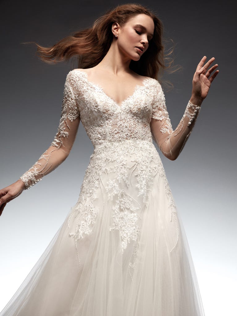 Flared wedding dress with voluminous yet lightweight tulle skirt with lace embroidered with floral motifs. For brides who dream of a romantic, feminine dress to say “I do.”
