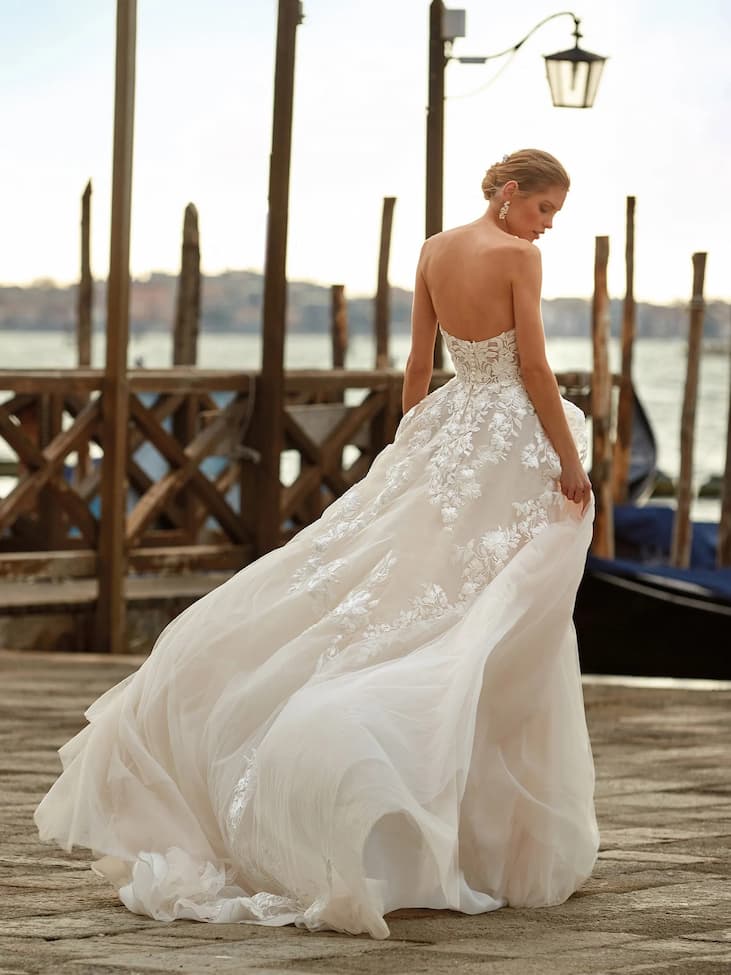 Mujer con vestido de novia y con un peinado de novia recogido en un puerto